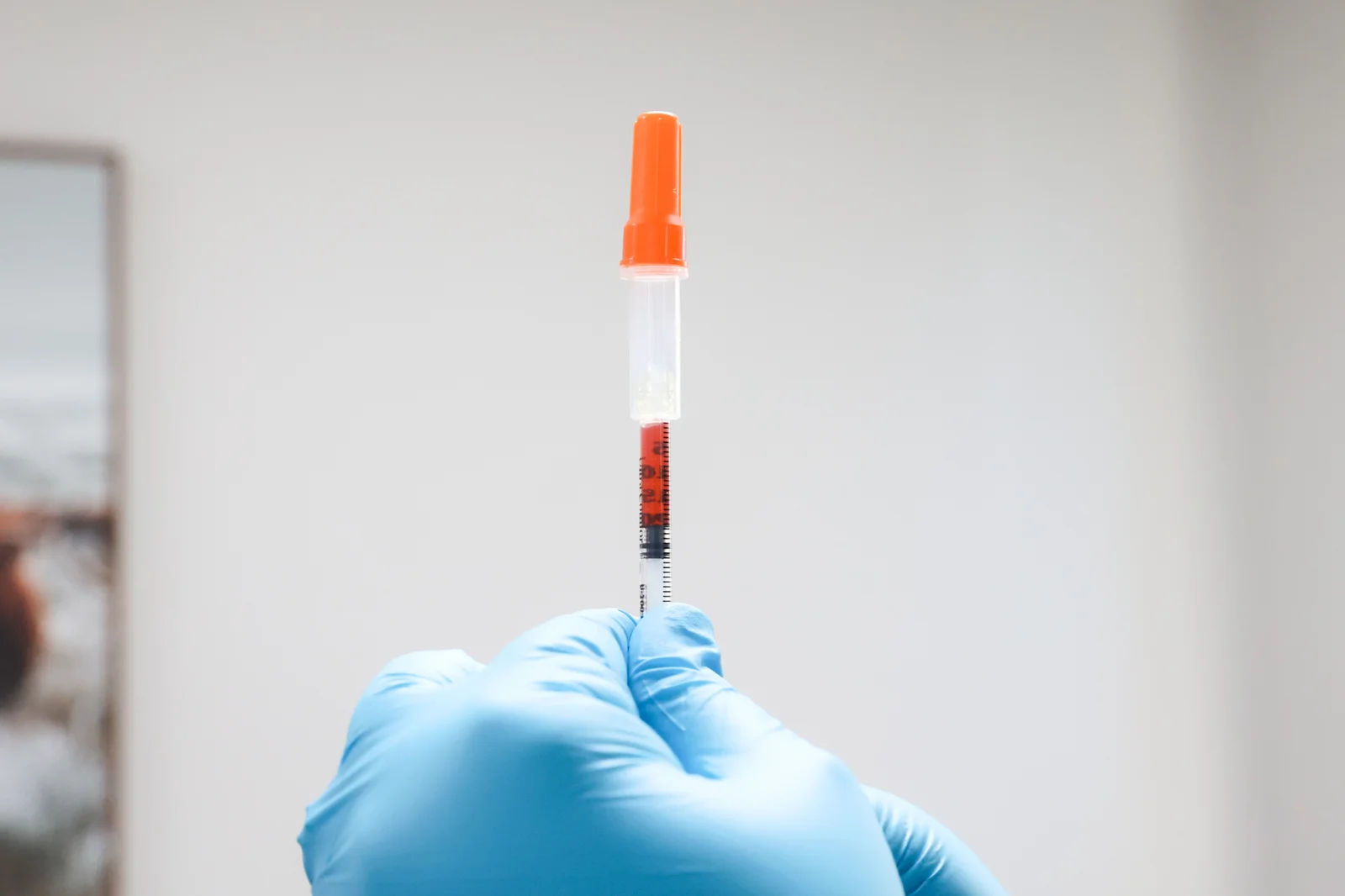 Wellness professional preparing a vitamin injection